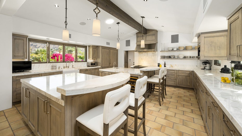 The kitchen features two eat-in islands and many enviable appliances.