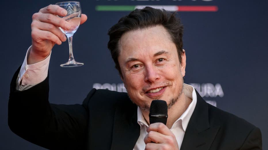 Elon Musk raising a glass to toast