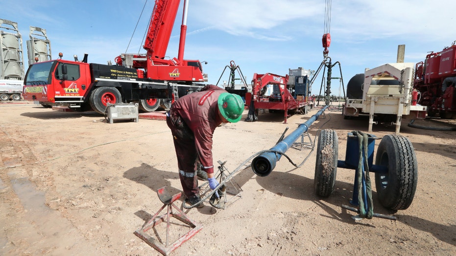 Halliburton's employees work at a three wellhead fracking site Monday, June 26, 2017, in Midland, Texas.